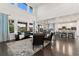 Spacious living room features high ceilings, large windows, and hardwood floors with modern furnishings at 19894 W 94Th Ln, Arvada, CO 80007