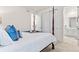 Spacious primary bedroom with four-poster bed, closet, and ensuite bathroom at 19894 W 94Th Ln, Arvada, CO 80007