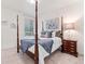 Primary bedroom with four-poster bed, carpet, and natural light from window at 19894 W 94Th Ln, Arvada, CO 80007