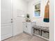 Functional mudroom with built-in bench, storage baskets, cabinet, and natural light from window at 19894 W 94Th Ln, Arvada, CO 80007