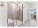 Modern walk-in shower with tile, bench, and glass enclosure at 19894 W 94Th Ln, Arvada, CO 80007