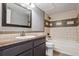 Bathroom featuring large mirror, sink with granite counter, and a tub and shower combination at 9995 E Harvard Ave # 166, Denver, CO 80231