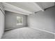 Bedroom featuring gray walls, gray carpet, a window, and white ceiling beams at 9995 E Harvard Ave # 166, Denver, CO 80231