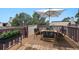 Charming outdoor deck featuring dining table with umbrella and seating at 9995 E Harvard Ave # 166, Denver, CO 80231