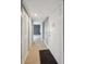 Bright hallway featuring light wood flooring and white doors adding contemporary design at 9995 E Harvard Ave # 166, Denver, CO 80231