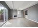 Bright living room with gray walls, fireplace, and a sliding glass door opening to a balcony at 9995 E Harvard Ave # 166, Denver, CO 80231