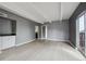 Spacious living room featuring gray walls, wood floors, and a sliding door to a balcony at 9995 E Harvard Ave # 166, Denver, CO 80231