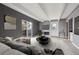 Modern living room with gray walls, beamed ceiling, fireplace, and sliding door to a balcony at 9995 E Harvard Ave # 166, Denver, CO 80231