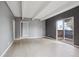 Bright living room featuring gray walls, wood floors, and a sliding door to a balcony at 9995 E Harvard Ave # 166, Denver, CO 80231