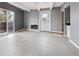 Bright living room with gray walls, fireplace, and a sliding glass door opening to a balcony at 9995 E Harvard Ave # 166, Denver, CO 80231