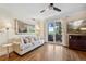 Bright living room with wood floors, neutral colors, ceiling fan, and sliding glass doors to let in the light at 2121 Enterprise St, Superior, CO 80027