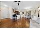 Open-concept living area with hardwood floors, neutral colors, ceiling fan, and ample space for entertaining at 2121 Enterprise St, Superior, CO 80027