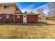 Red brick house exterior with a door and window in the backyard, showing well-kept lawn and property line at 3611 W 79Th Ave # B4, Westminster, CO 80030