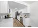 Galley kitchen with stainless steel appliances, quartz countertops, and white cabinetry at 3611 W 79Th Ave # B4, Westminster, CO 80030