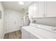 Laundry room equipped with washer, dryer, and white cabinets for storage at 3611 W 79Th Ave # B4, Westminster, CO 80030