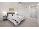 Bright main bedroom with a ceiling fan, comfortable bed, and white closet doors at 3611 W 79Th Ave # B4, Westminster, CO 80030