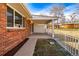 Red brick house featuring a covered patio perfect for outdoor lounging and entertainment at 3611 W 79Th Ave # B4, Westminster, CO 80030