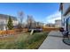 Fenced backyard featuring a patio, trampoline and green grass at 1995 E 166Th Ave, Thornton, CO 80602