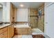 Bathroom featuring double vanity, soaking tub, and separate glass-enclosed shower at 1995 E 166Th Ave, Thornton, CO 80602