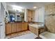 Bathroom featuring double vanity, soaking tub, and separate glass-enclosed shower at 1995 E 166Th Ave, Thornton, CO 80602