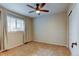 Cozy bedroom featuring neutral carpet, a ceiling fan, window with blinds, and a closet at 1995 E 166Th Ave, Thornton, CO 80602