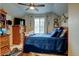 Bright bedroom with blue bedding, ceiling fan, and natural light coming through the window at 1995 E 166Th Ave, Thornton, CO 80602