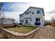 Back of home features a lawn, patio, trampoline, and retaining wall, perfect for outdoor entertaining at 1995 E 166Th Ave, Thornton, CO 80602