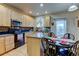 Kitchen showcases maple cabinets, granite countertops, and a table for four adjacent to a glass patio door at 1995 E 166Th Ave, Thornton, CO 80602