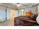 Large main bedroom with neutral color palette, ceiling fan, and multiple doorways at 1995 E 166Th Ave, Thornton, CO 80602