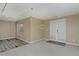 Finished basement featuring plush neutral carpet, wood flooring, white patio doors, and natural light at 9436 Cody Dr, Broomfield, CO 80021