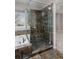 Bathroom featuring a shower and bathtub with patterned tiles, glass enclosure, and tile flooring at 9436 Cody Dr, Broomfield, CO 80021