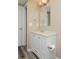 Bathroom featuring a sink with a white cabinet, a mirror, and decorative lights above the mirror at 9436 Cody Dr, Broomfield, CO 80021