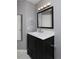 Bathroom featuring a sleek dark vanity cabinet with a white countertop and a large framed mirror at 9436 Cody Dr, Broomfield, CO 80021