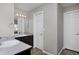 Bathroom featuring dual sinks, a large mirror, and white cabinets at 9436 Cody Dr, Broomfield, CO 80021