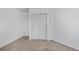 Bedroom featuring neutral carpet, white walls, closet and a door at 9436 Cody Dr, Broomfield, CO 80021