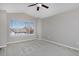 An empty bedroom featuring neutral-colored walls, large windows, and wall-to-wall carpet at 9436 Cody Dr, Broomfield, CO 80021