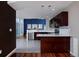 Modern kitchen featuring dark wood cabinets, stainless steel appliances, and an eat-in bar at 9436 Cody Dr, Broomfield, CO 80021