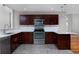 Updated kitchen featuring dark wood cabinets, stainless steel appliances, quartz countertops and modern fixtures at 9436 Cody Dr, Broomfield, CO 80021