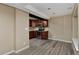 Basement kitchen with wood cabinets, stainless steel appliances, and durable gray wood-look flooring at 9436 Cody Dr, Broomfield, CO 80021