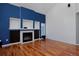 Spacious living room featuring a blue accent wall with built-in shelving and a cozy fireplace at 9436 Cody Dr, Broomfield, CO 80021