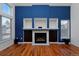 Living room features hardwood floors, a blue accent wall, and stylish fireplace with built-in shelving at 9436 Cody Dr, Broomfield, CO 80021