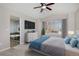 Bright main bedroom featuring a ceiling fan, a large window, and a view of a luxurious bathtub at 9436 Cody Dr, Broomfield, CO 80021