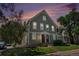 Charming two-story home at dusk with landscaped front yard and inviting red front door at 2239 S Jasper Way # A, Aurora, CO 80013