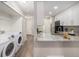 Open-concept kitchen and laundry area with granite countertops and stainless appliances at 2239 S Jasper Way # A, Aurora, CO 80013