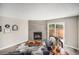 Comfortable living room with tile fireplace and sliding glass door to backyard at 2239 S Jasper Way # A, Aurora, CO 80013