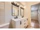 Modern bathroom features a double vanity with marble countertop and sleek black fixtures at 6537 Everett St, Arvada, CO 80004