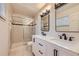 Bathroom with double vanity, modern fixtures and a glass enclosed shower at 6537 Everett St, Arvada, CO 80004