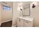 Updated bathroom features a stylish vanity with modern fixtures and a framed mirror at 6537 Everett St, Arvada, CO 80004