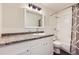 Well-maintained bathroom with shower-tub combo and ample counter space for functionality at 6537 Everett St, Arvada, CO 80004