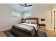 Bedroom with plush bedding, ceiling fan, neutral walls and hardwood floors at 6537 Everett St, Arvada, CO 80004